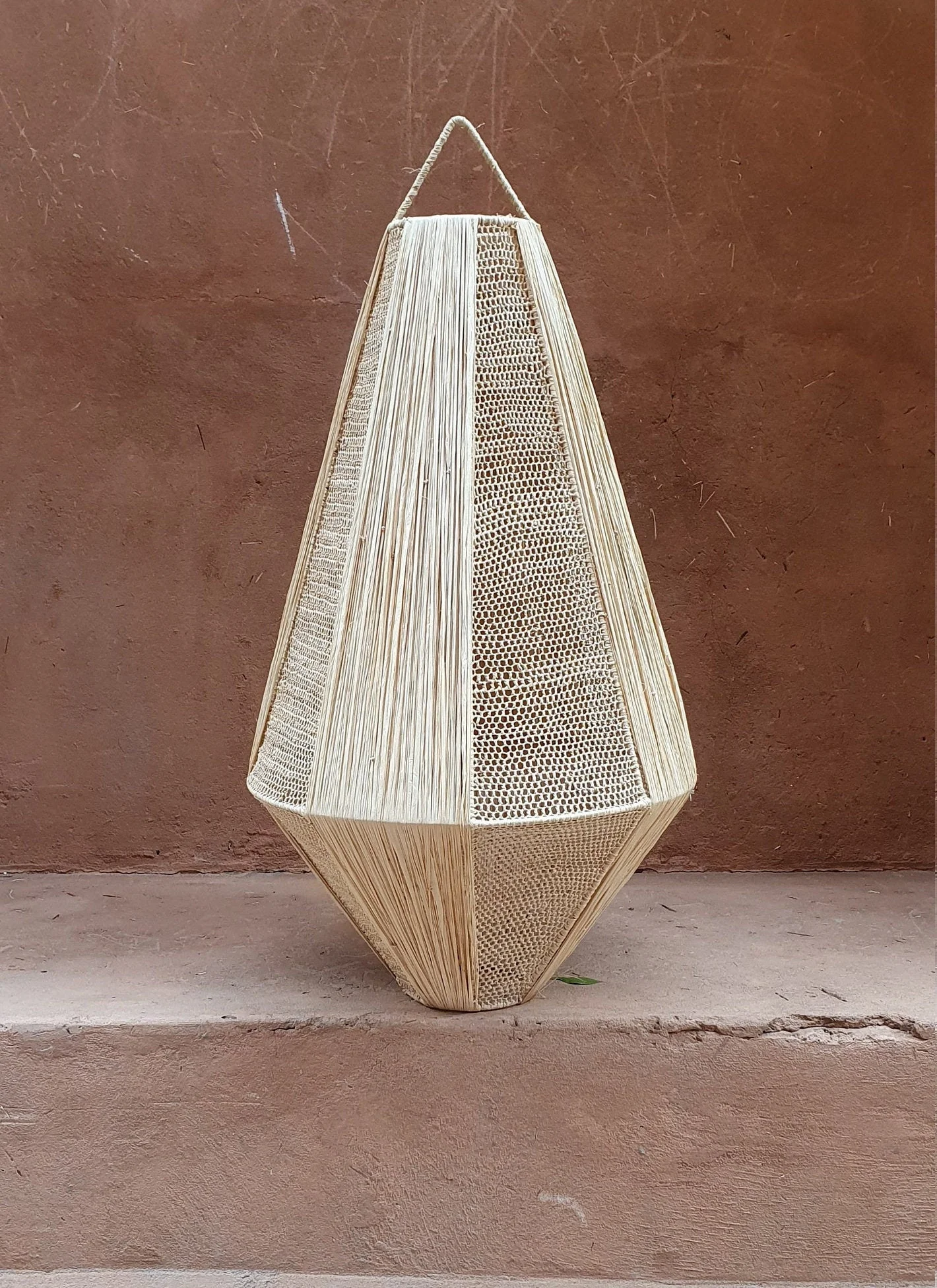 Hand-crafted hanging lamp in raffia