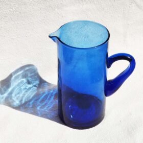 Handmade Moroccan recycled glass pitcher in green, amber, and clear colors crafted by local artisans 1