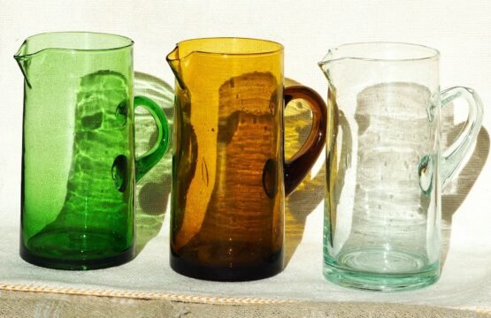 Handmade Moroccan recycled glass pitcher in green, amber, and clear colors crafted by local artisans